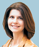 An image of Lee-ann Leitch, a woman with brown medium long hair wearing a blazer.