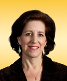 An image of Nancy Walker, a woman with short brown hair wearing a brown blazer