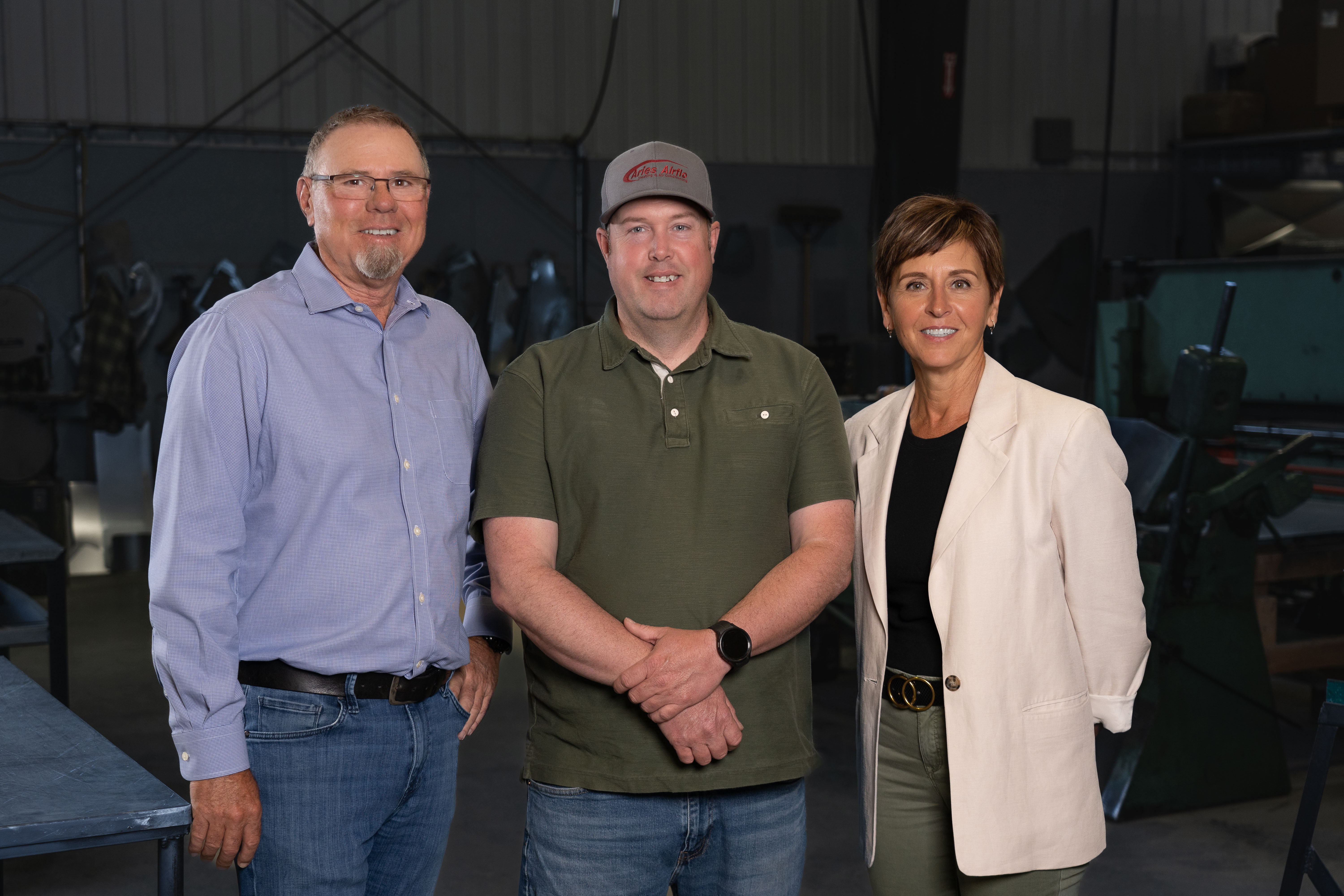 Two males and one female standing next to each other.